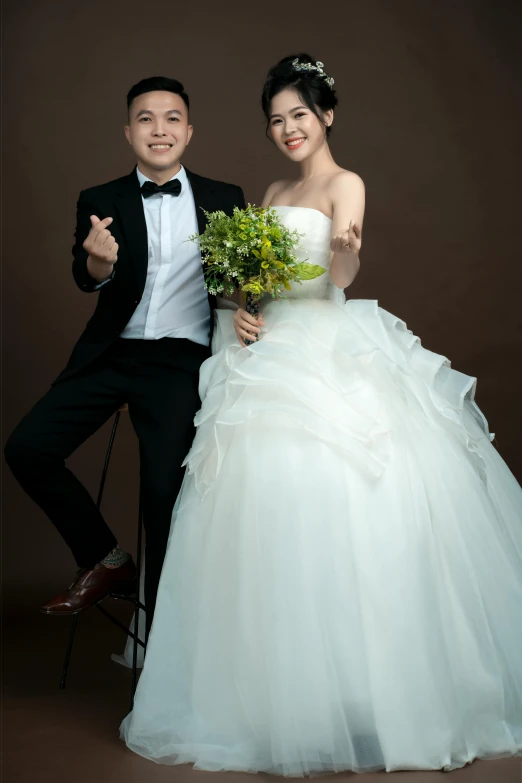 an asian couple poses for a wedding po