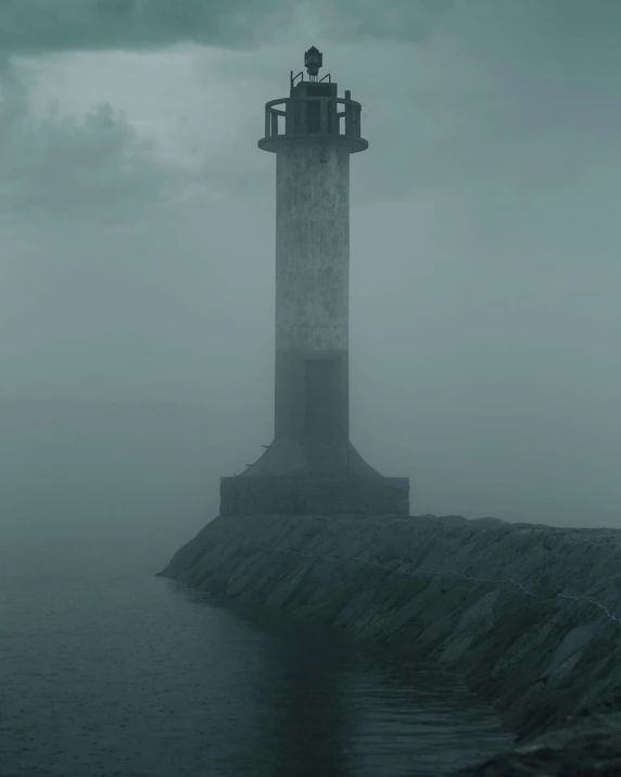 lighthouse with wind vane out on dark sea