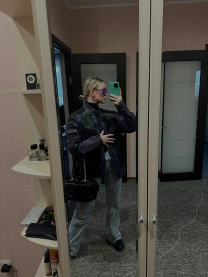 a woman taking a selfie while standing in front of a mirror