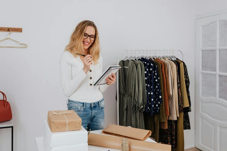 a woman looking at boxes and checking out clothes