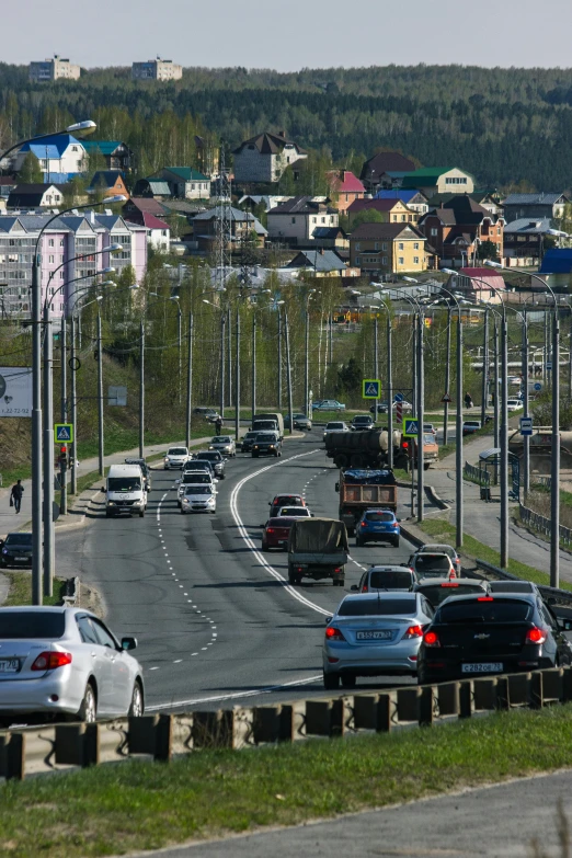 a highway full of cars and a mountain is seen behind