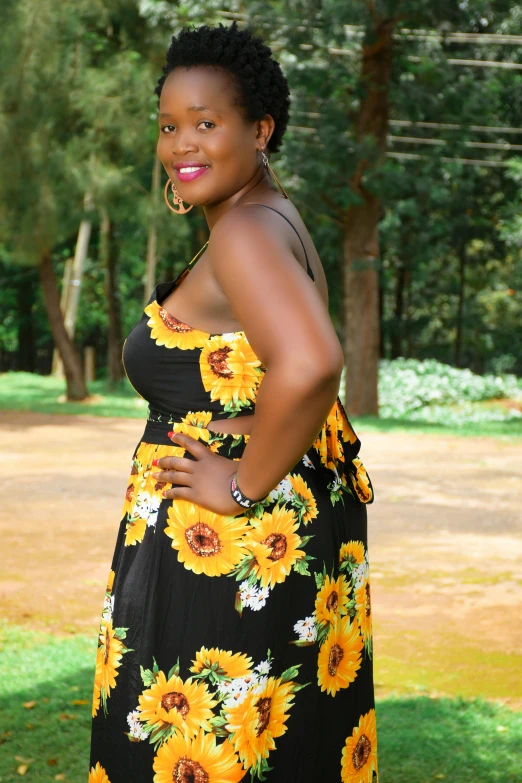 woman in sunflower print dress posing for camera