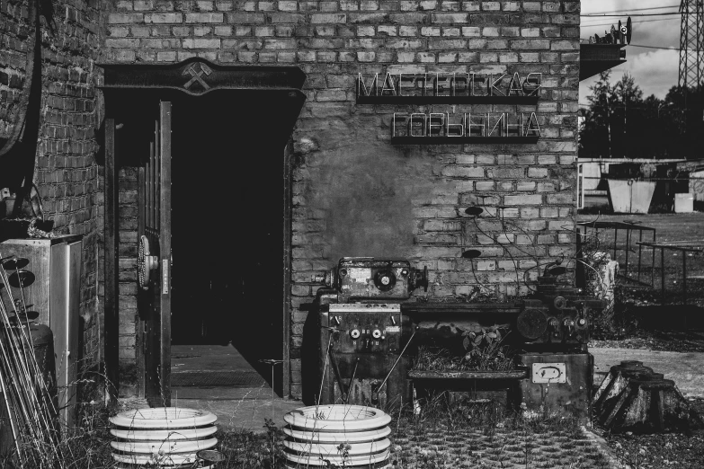 the front of a home with a brick wall and garage doors