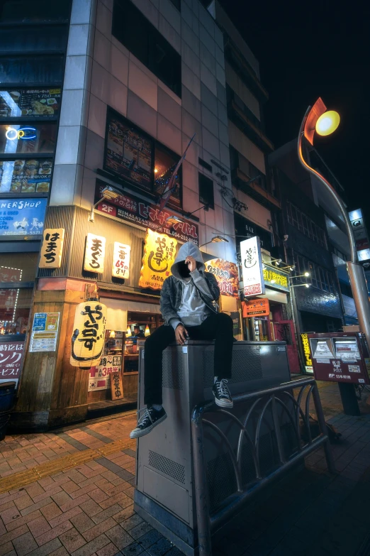 man sitting in chair on street corner in urban setting