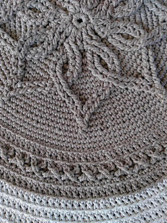 an odd crochet blanket on a white surface
