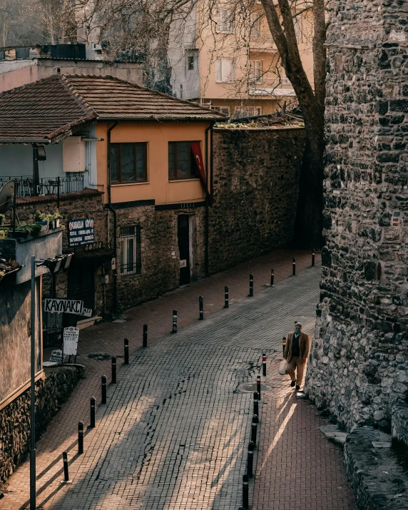 a stone street with several buildings on the side