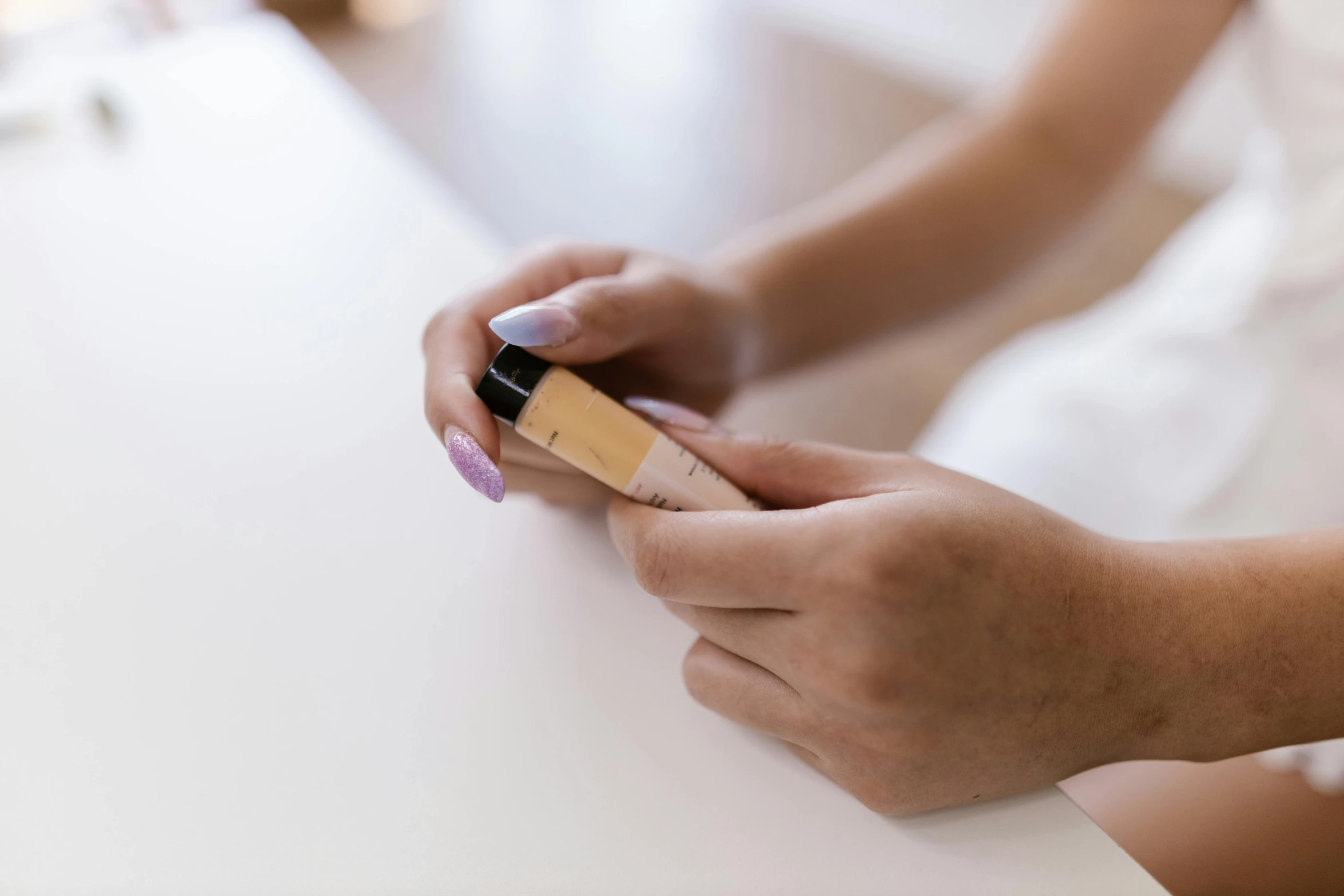 closeup of woman using nail polish to do it