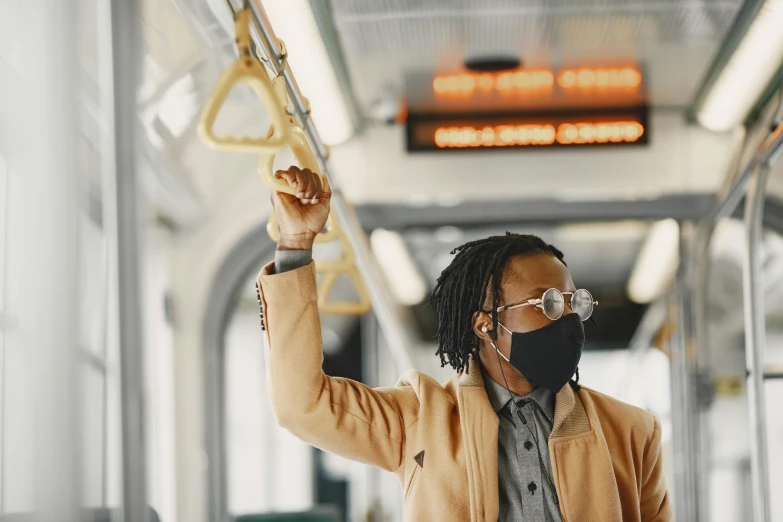 a woman riding on top of a bus wearing a black mask