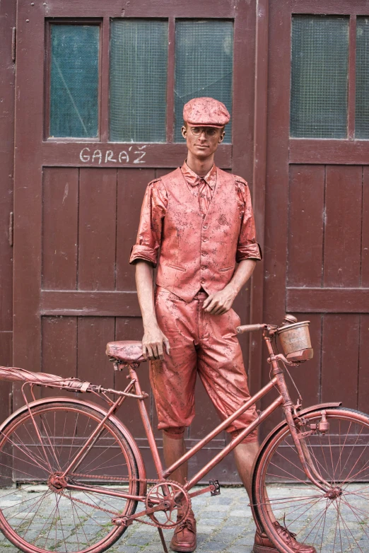 a bicycle parked on the side of a street next to a man in orange clothing