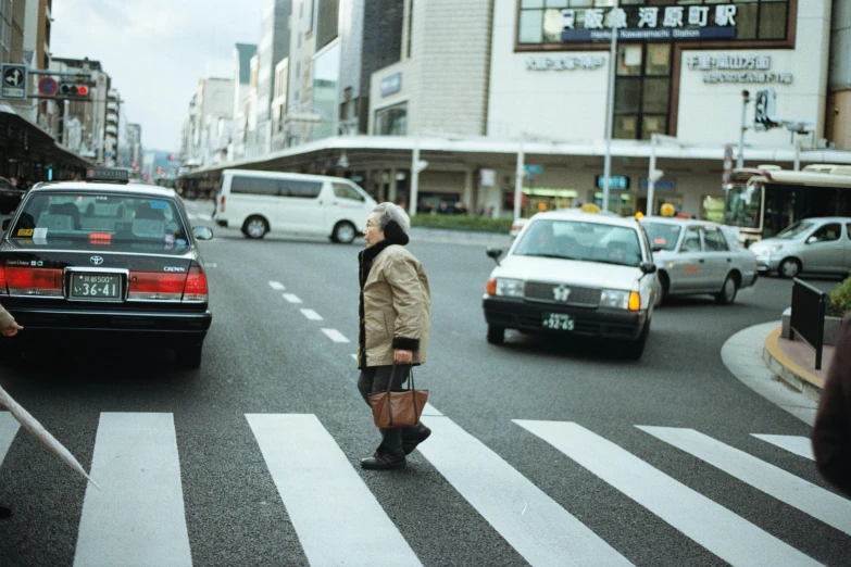 a person is walking across a busy street