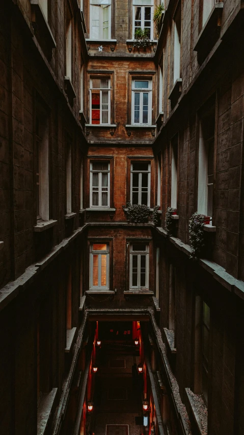 the interior courtyard of an apartment building with a red fire hydrant