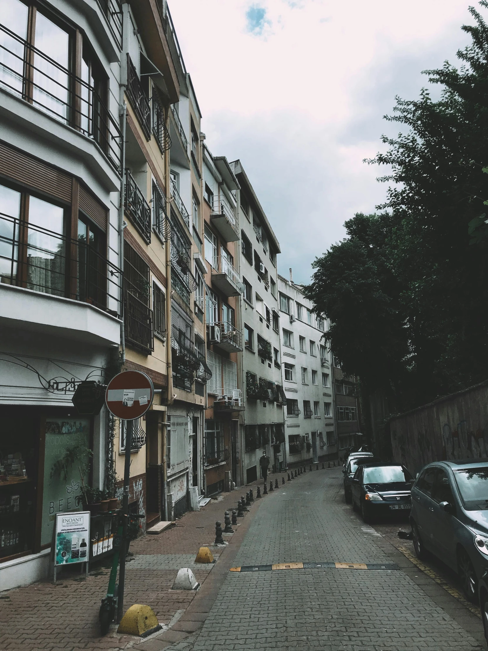 a city street is lined with apartment buildings