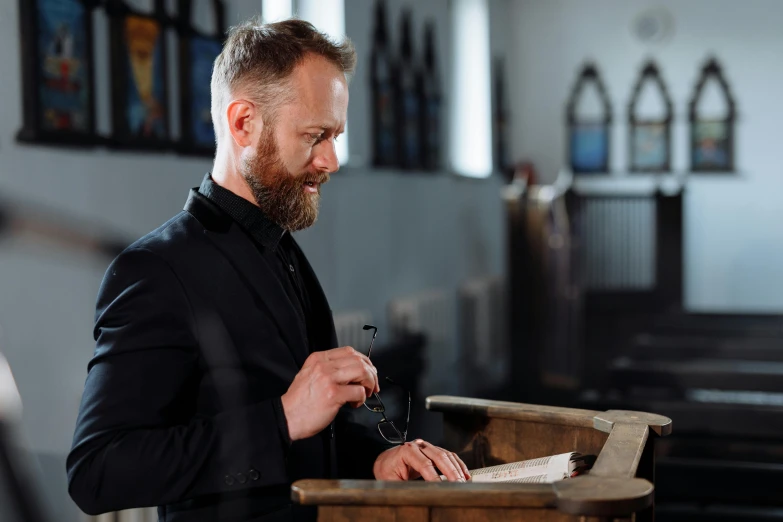 a man reading a prayer in a small church