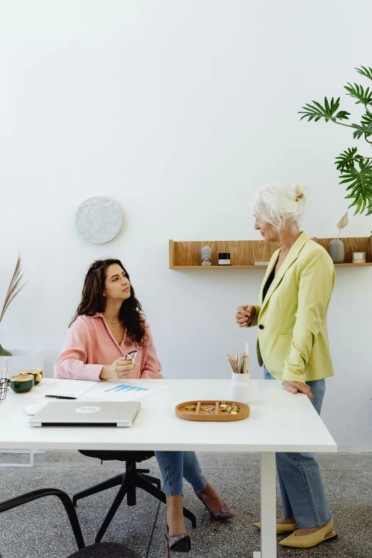 two women are having a conversation at a table