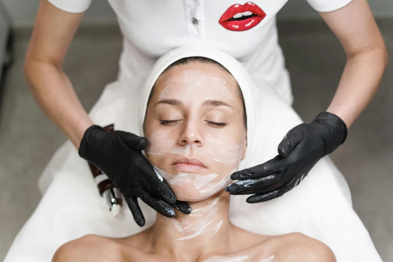 a woman getting facial massage on her face
