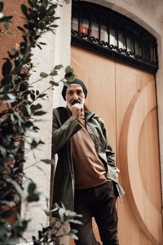 a man standing in front of a wooden door