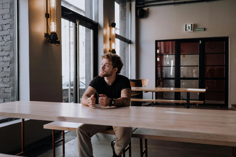 the man is sitting at the table with his fist up