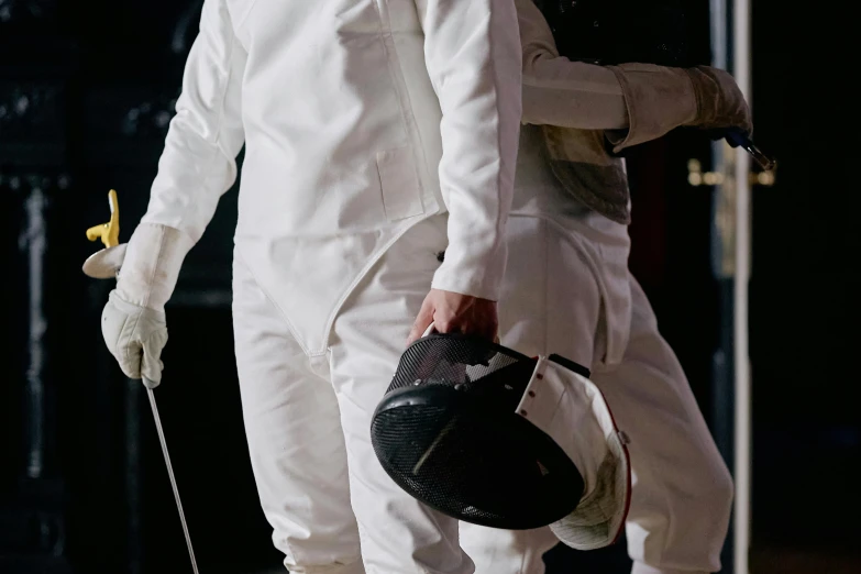 man and woman in formal white suits walk down the street