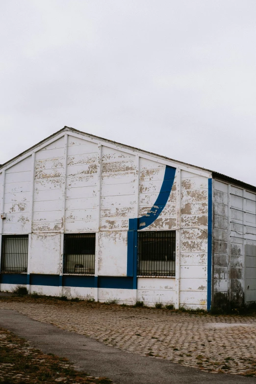the exterior of an old abandoned building with blue accents