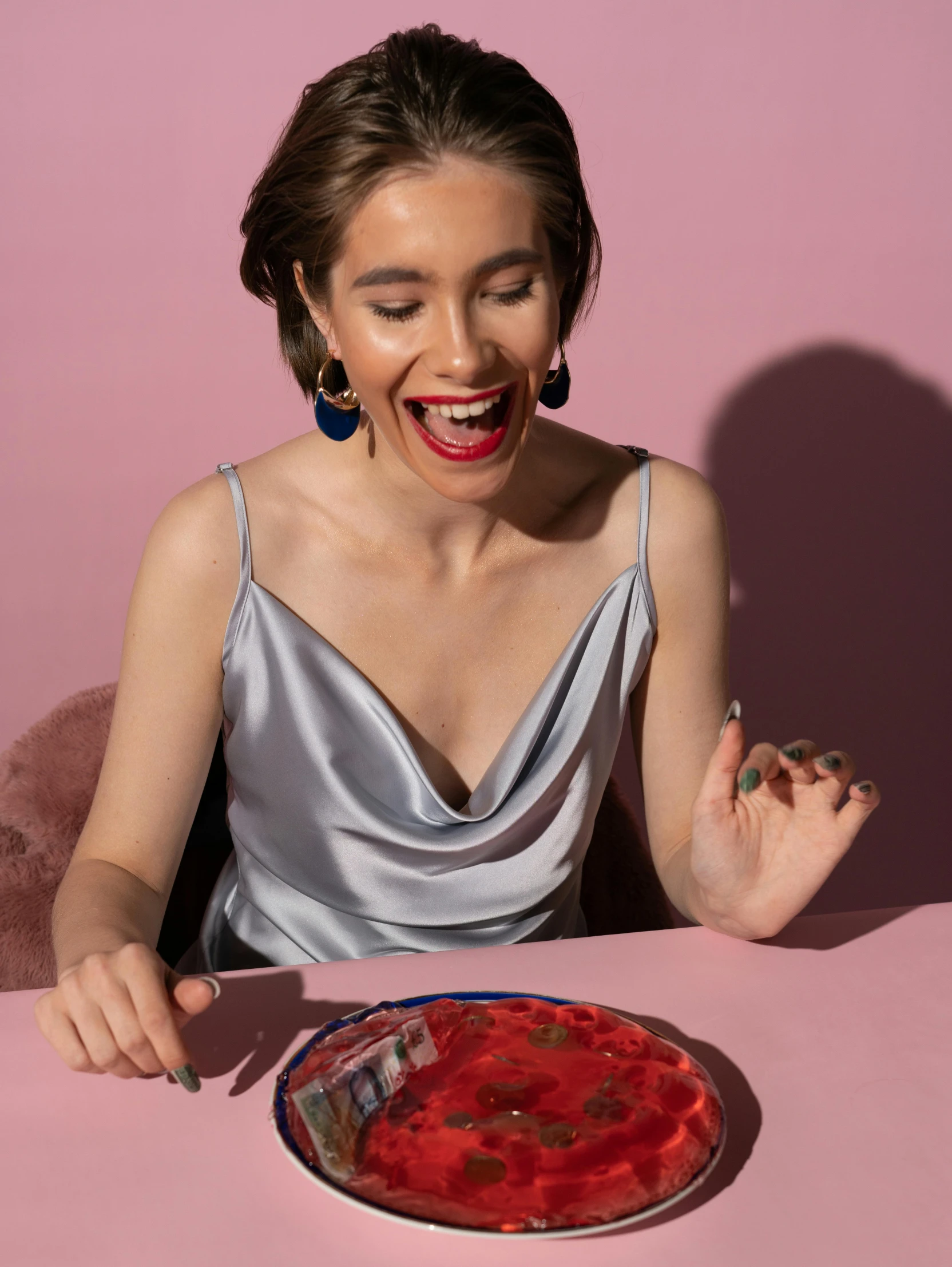 a woman at the table, with red and green dessert