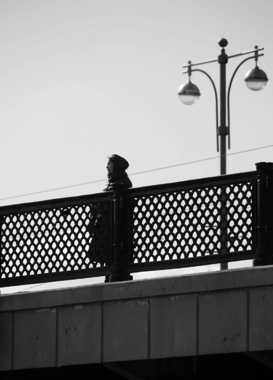 a person is walking on the edge of a bridge