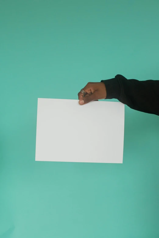a person with their hand on the paper