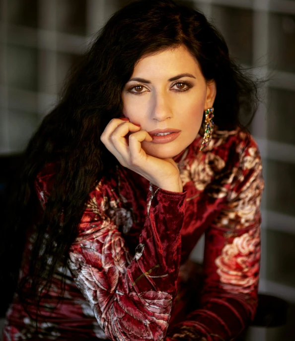 a woman posing for the camera with her hands on her chin