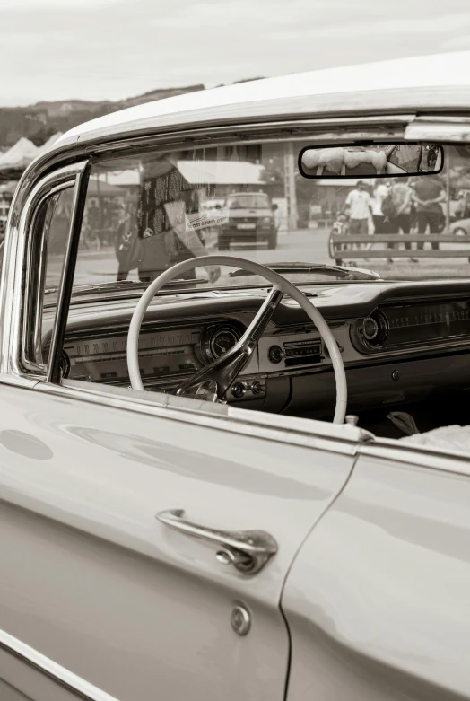 a classic car is seen in a black and white po