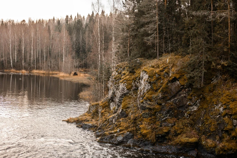 a cliff overlooking the edge of a small river