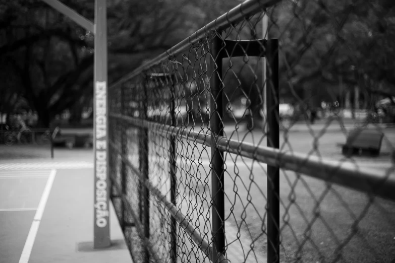 a black and white pograph of a metal fence