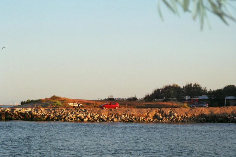 a view of a red farm with a tractor next to it