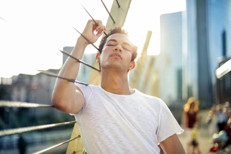 a man is holding on to some kind of wooden pole