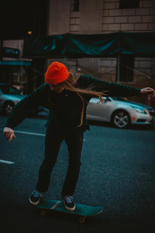 the  is riding her skateboard on the road