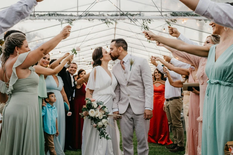 some people and one person are holding flowers