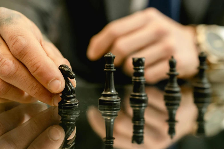 a man playing chess with his fingers in the shape of animals