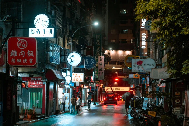 the sidewalk is dark and full of signs