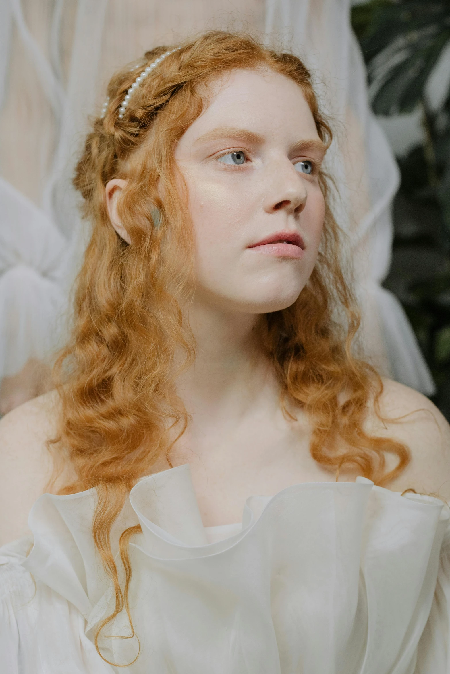 an redheaded woman wearing a white dress with a id