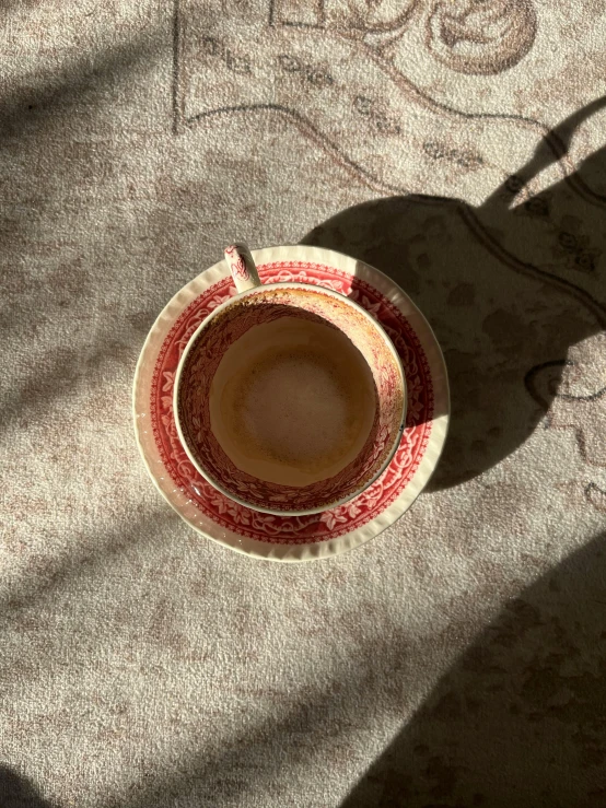 a cup is seen from above on a saucer