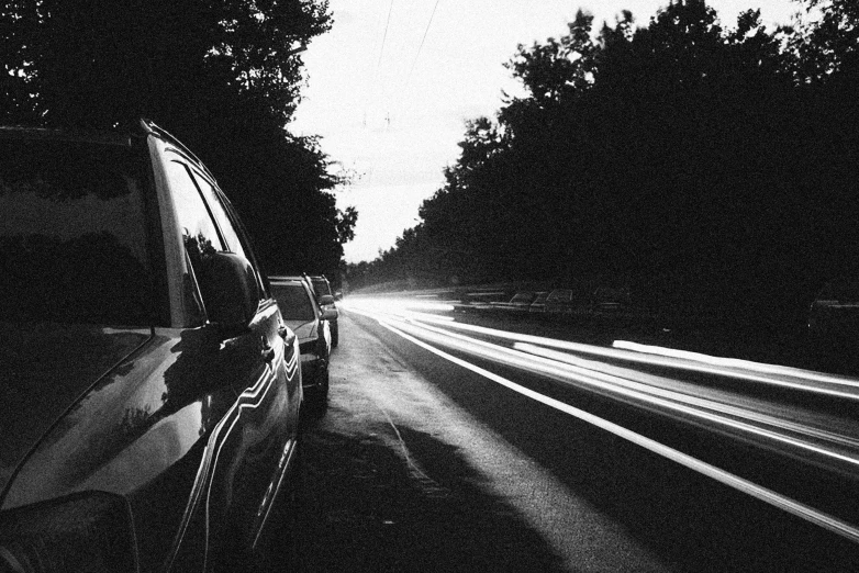 the car is driving down the highway in the dark