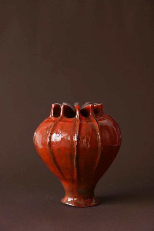 a red vase on a brown background