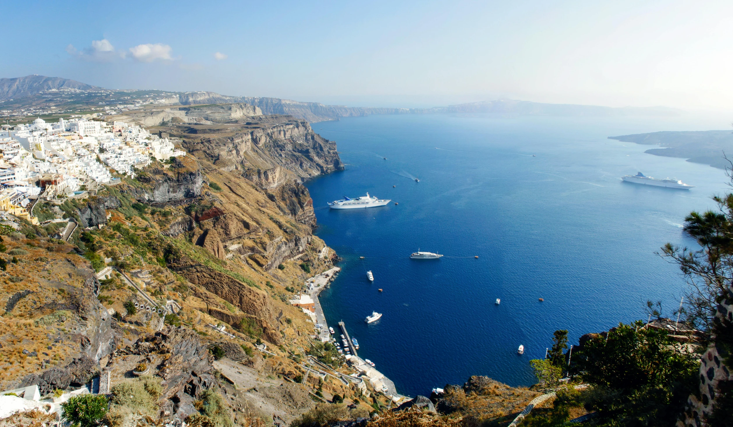 a city on the top of a cliff overlooking water