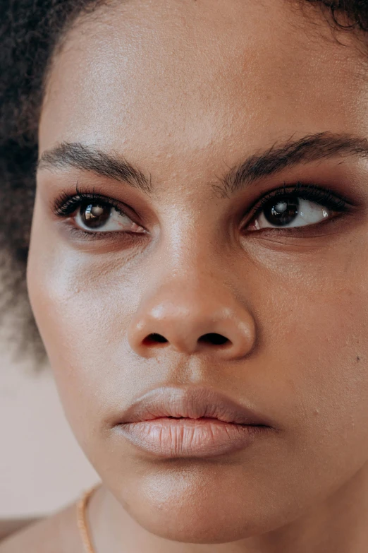 a close up of a woman's face wearing a necklace