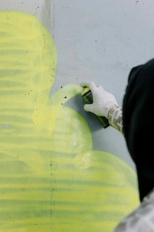 a person painting an object on a wall