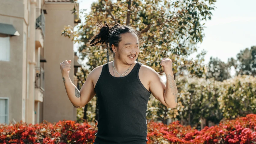 man running outdoors holding a tennis racket in the air