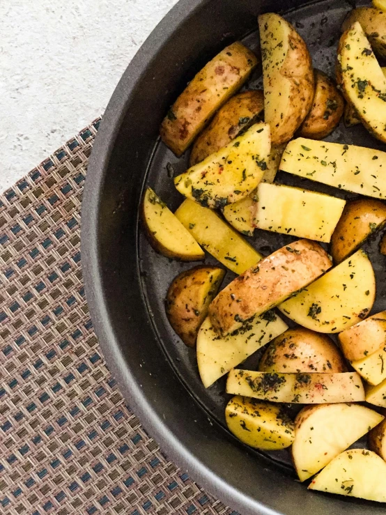 cooked potatoes with pepper and garlic in a pan