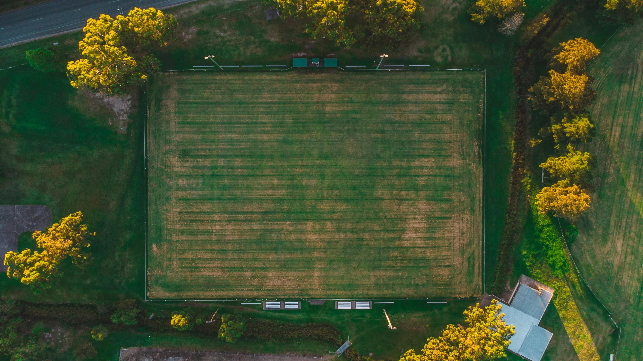 a large grassy field surrounded by trees