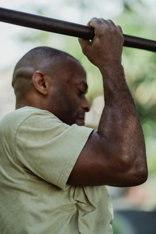 a man with no arms holds the bars to his face