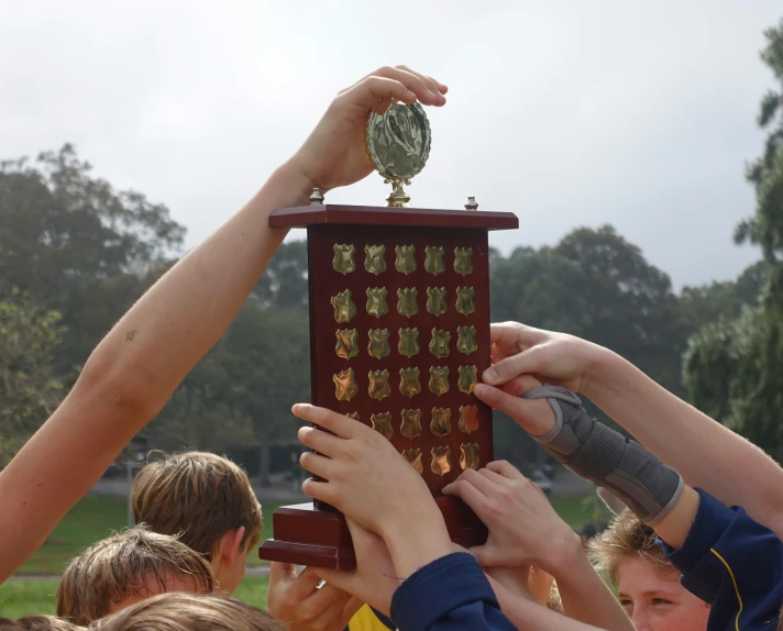 a large group of young people holding up an award