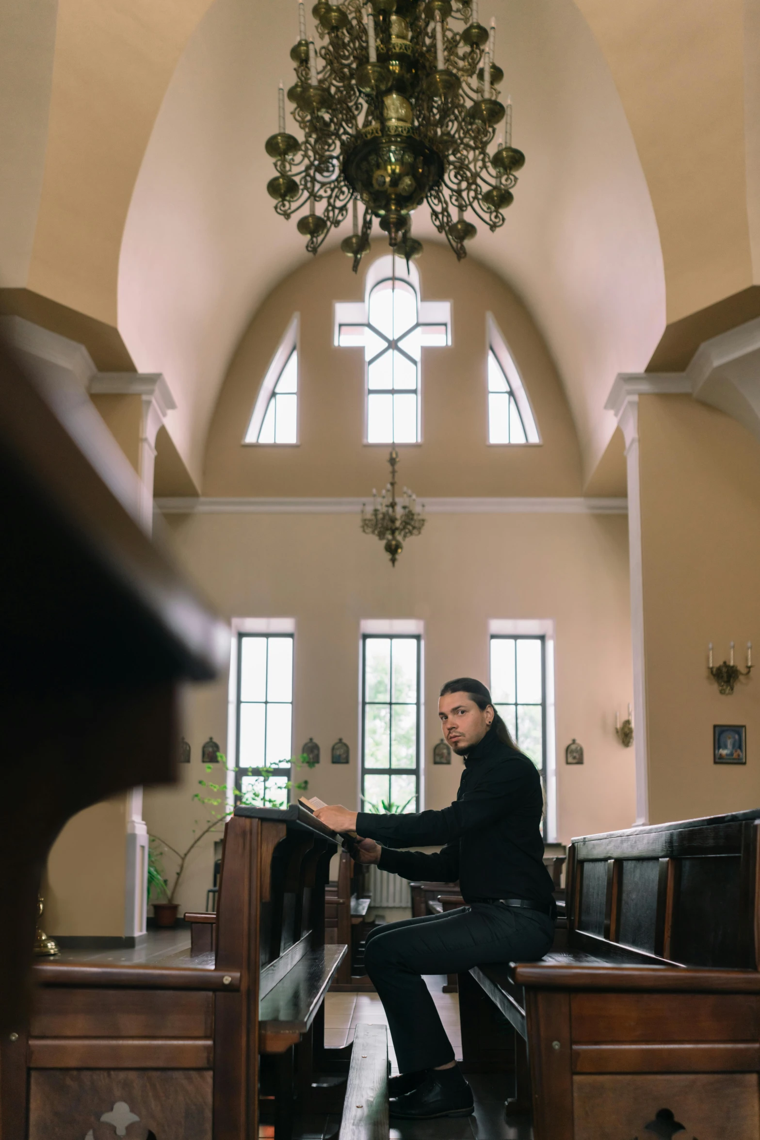 a person sitting on a piano in a church