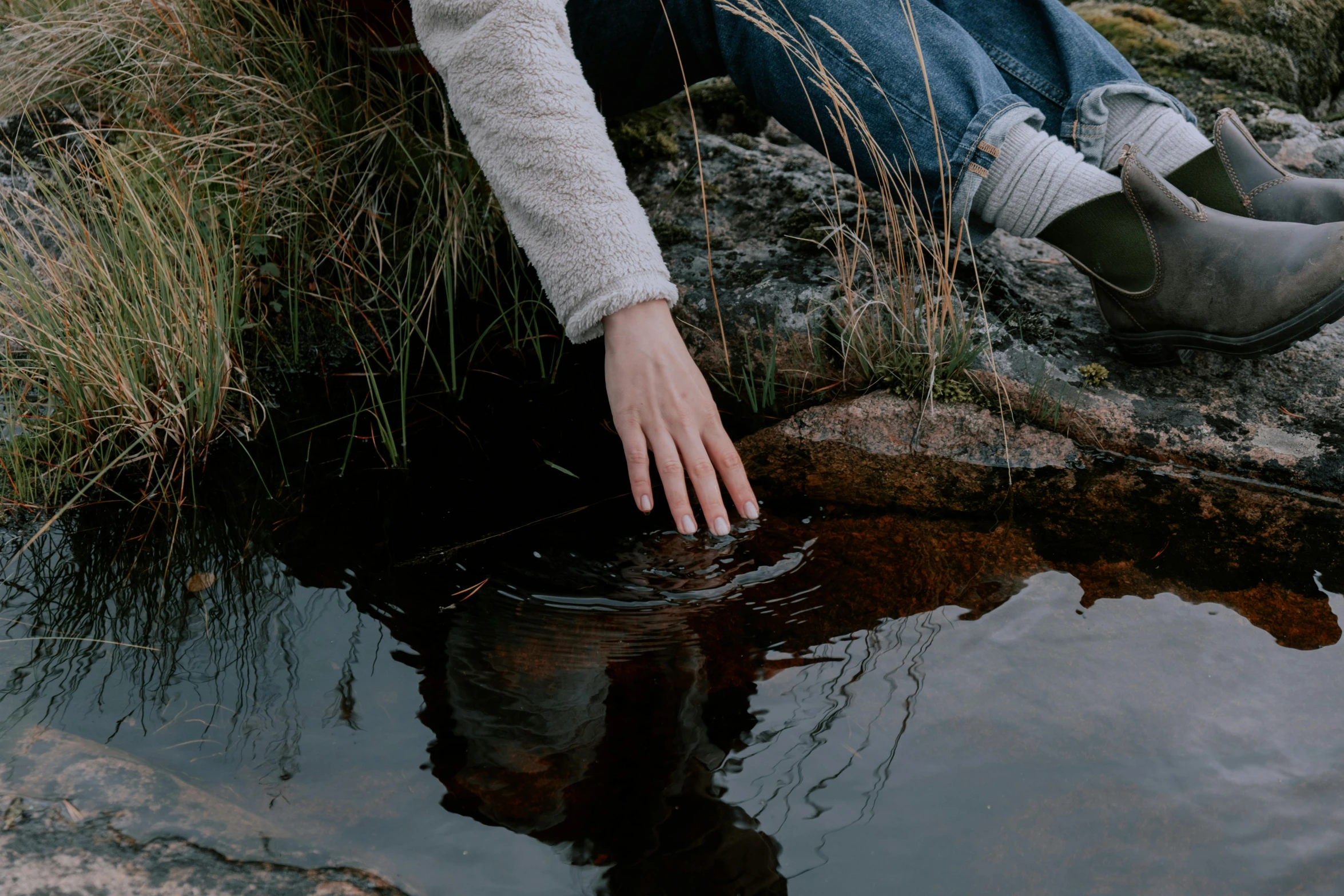 a hand that is sticking out of the water